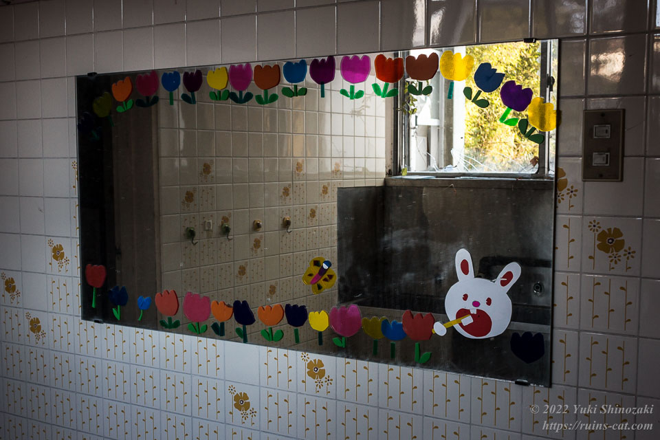 チューリップやウサギが描かれた寮のトイレの鏡